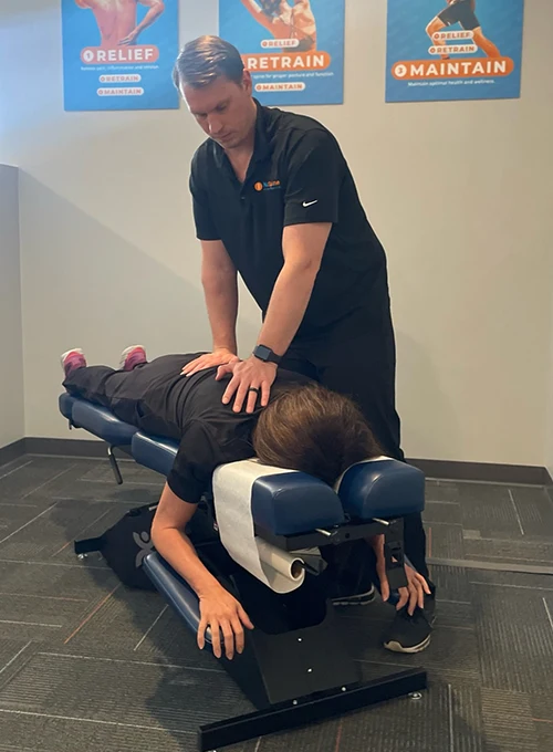 Chiropractor-Leander-TX-NuSpine-Dr-James-Perry-Adjusting-Patient.webp